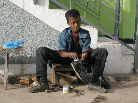 'Teddy'. Cleaning shoes in order to save up for a plane ticket out of Ethiopia.